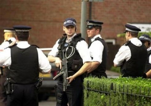 Police guard a cul-de-sac on Scotia Road in Streatham, south London, Saturday July 23, 2005. Residents described Saturday how police raided a house in the street earlier in the afternoon. One neighbour, who only wanted to be named as Marcia, said several police vans had stormed into the area before armed officers rushed to the address and ordered residents to get inside their houses. She said: 'They had already sealed it off and then the officers with guns came along telling us: 'Get inside or you will be arrested.' (AP Photo/PA, Lindsey Parnaby)